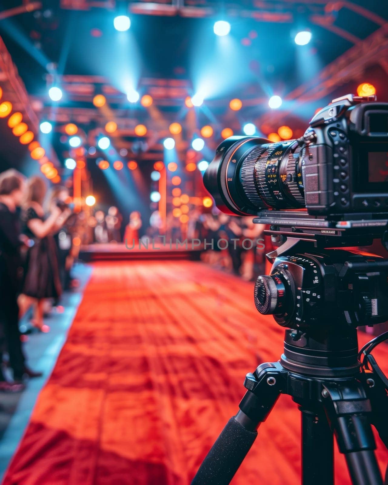 Professional camera on tripod at a red carpet event with blurred background of guests and lights by sfinks