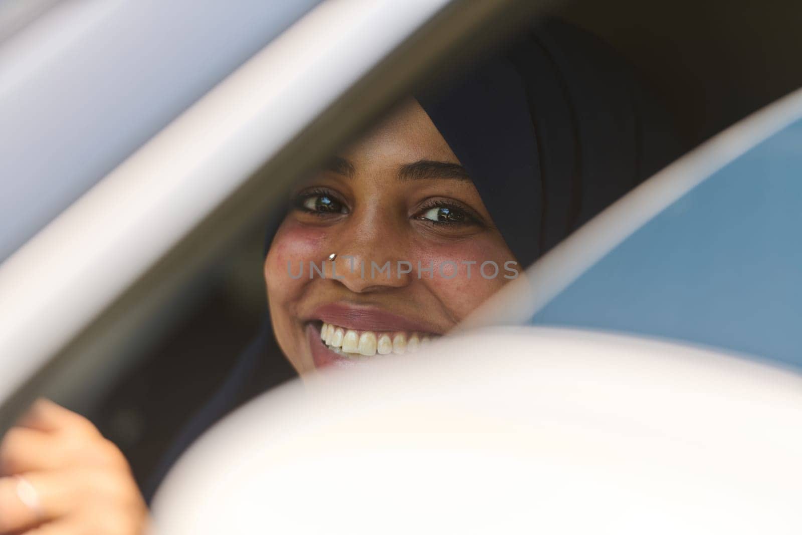 A Middle Eastern teenage girl enjoys a drive through scenic nature, embracing the freedom and beauty of the outdoors.