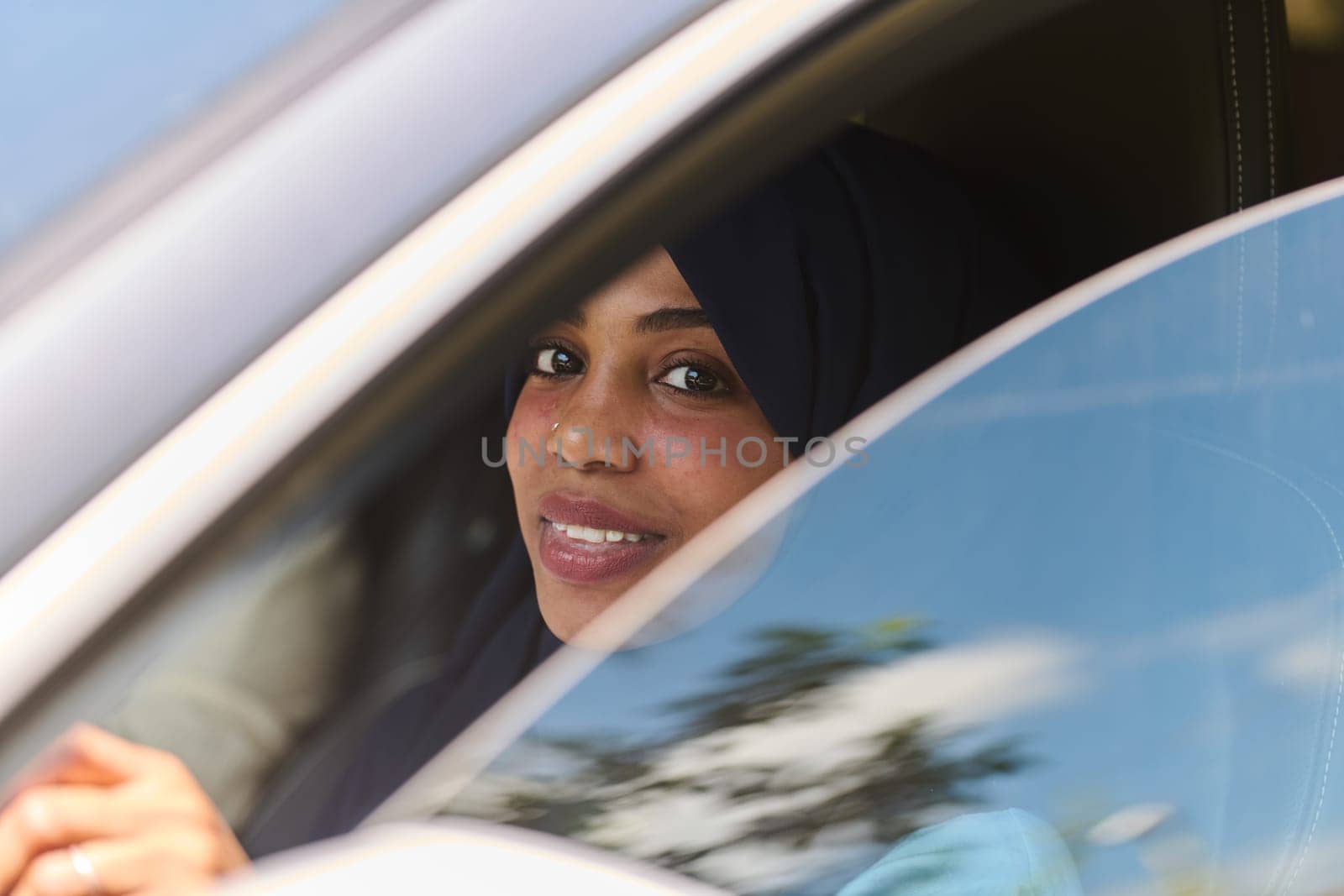 A Middle Eastern teenage girl enjoys a drive through scenic nature, embracing the freedom and beauty of the outdoors.