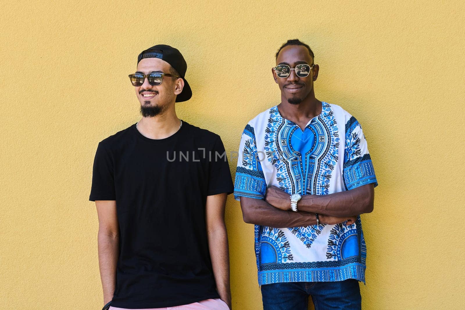 A depiction of camaraderie and cultural diversity two male friends, one an African American teenager dressed in Sudanese traditional attire, leaning against a vibrant yellow wall