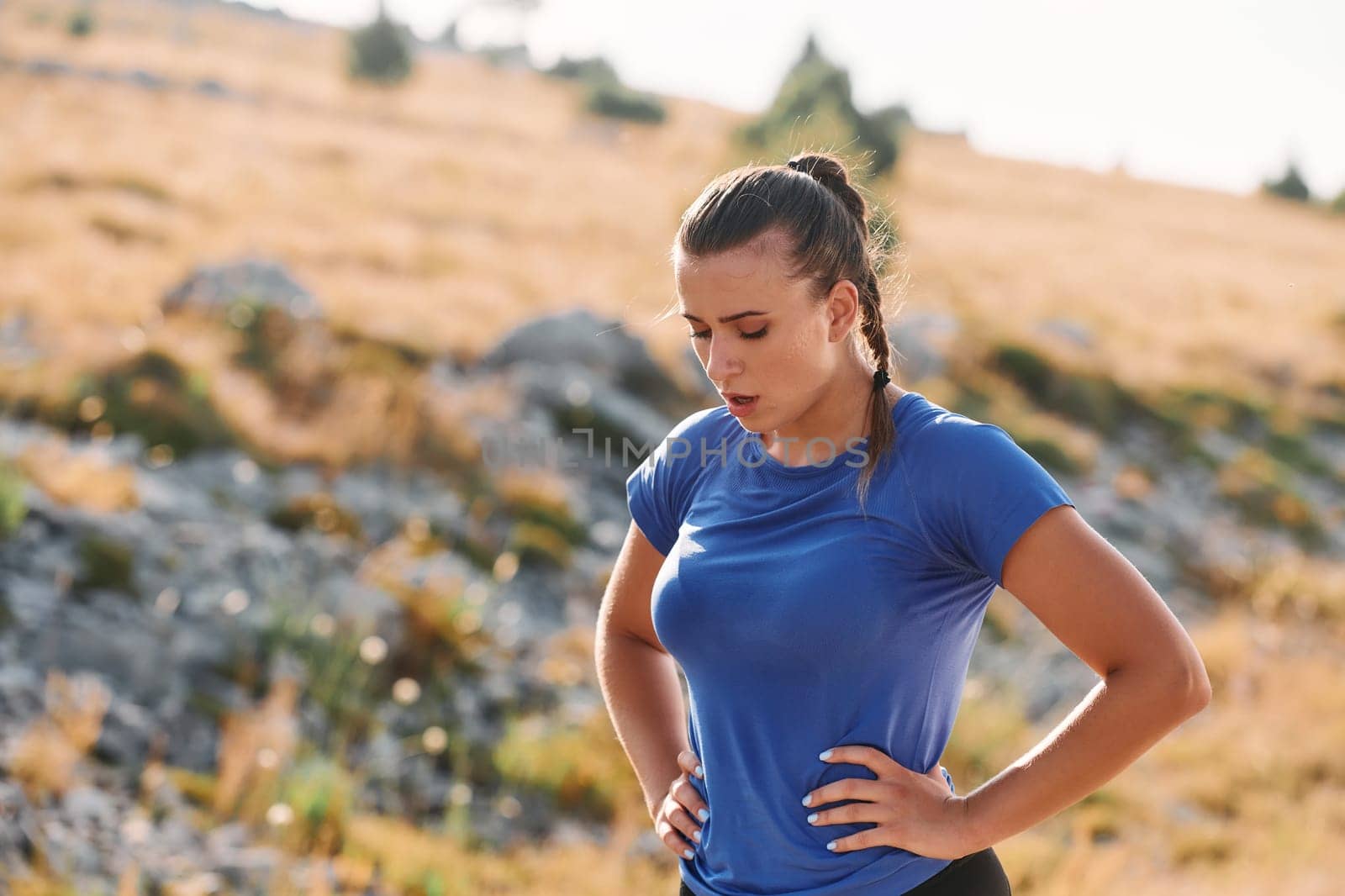 Determined Woman Athlete Preparing for Morning Run by dotshock