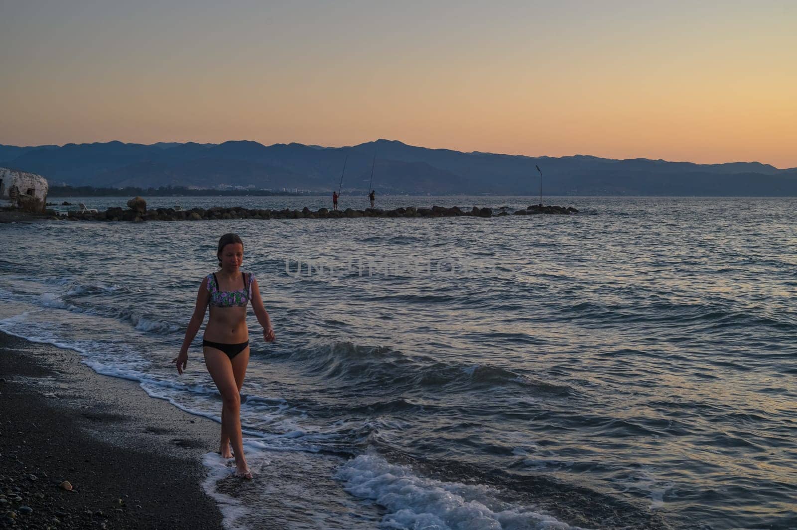 girl walking on the beach at sunset in Cyprus