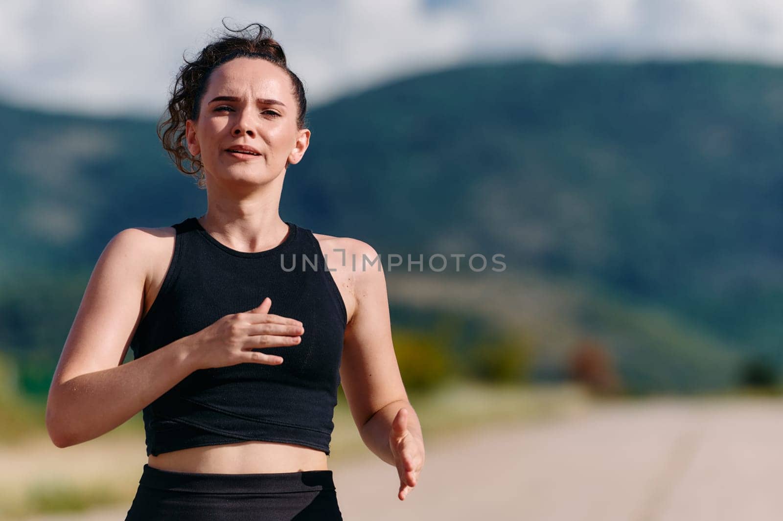 Rain or shine, a dedicated woman powers through her training run, her eyes set on the finish line.