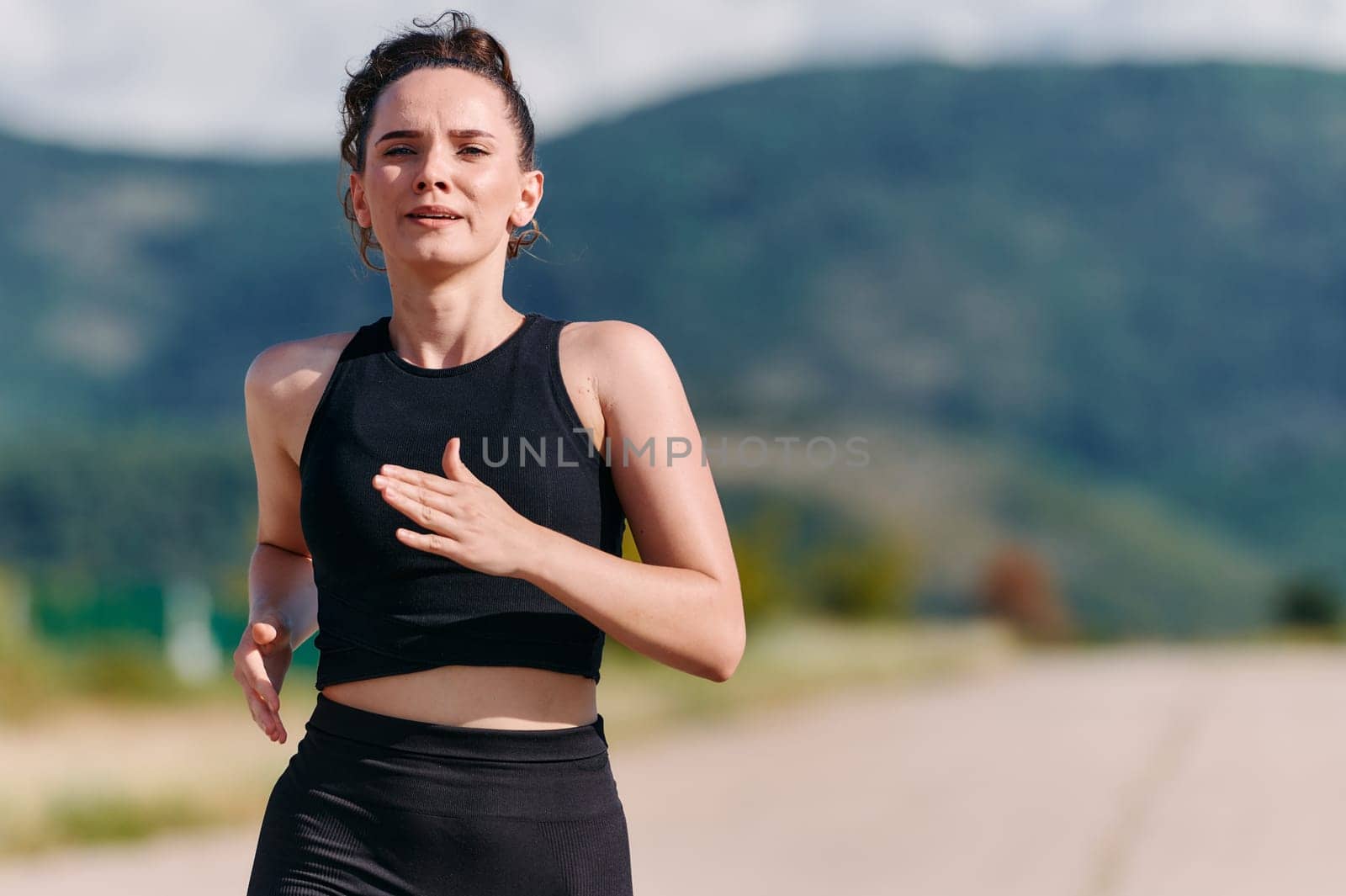 Rain or shine, a dedicated woman powers through her training run, her eyes set on the finish line.