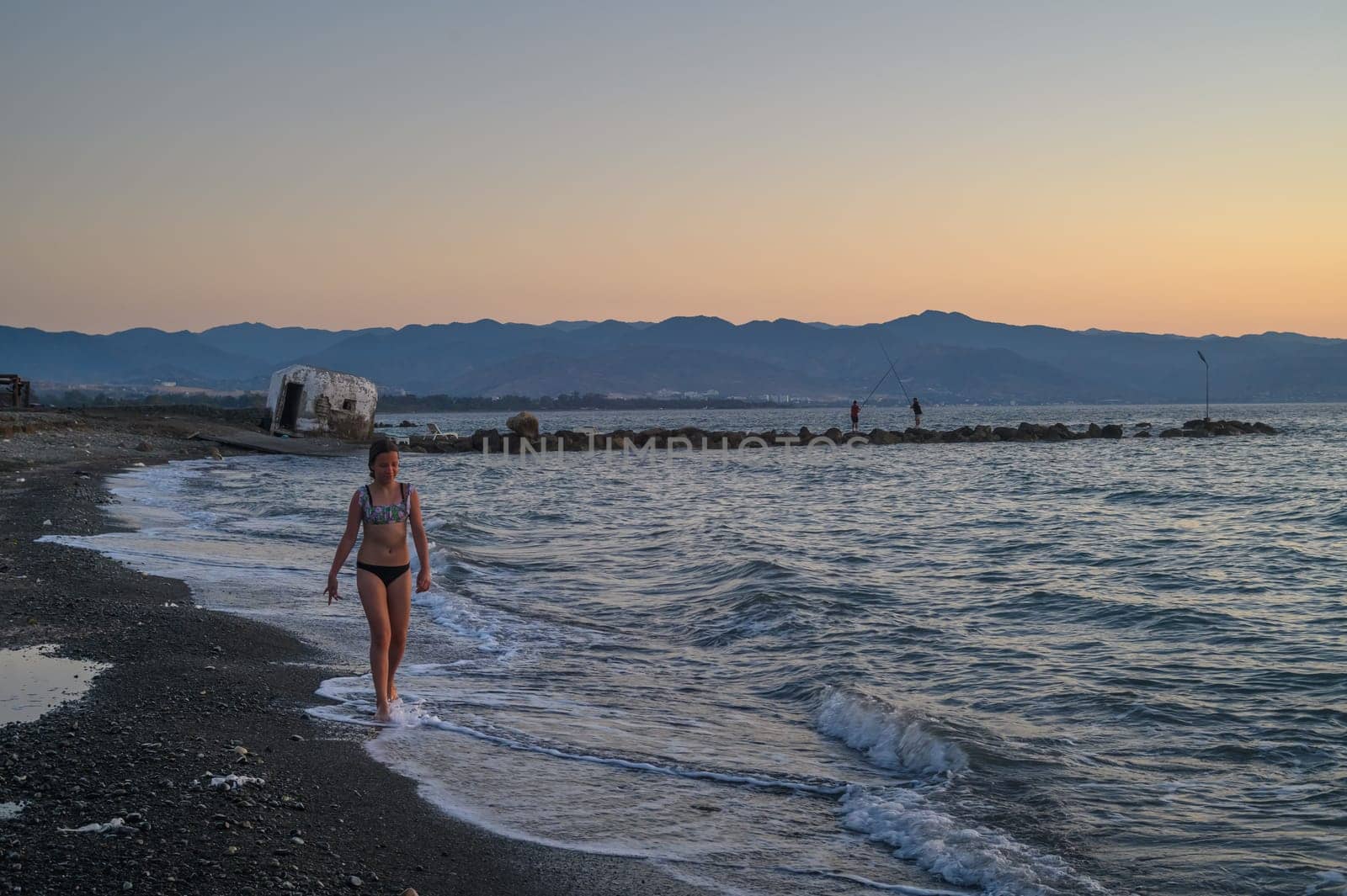 girl walking along the beach at sunset 3
