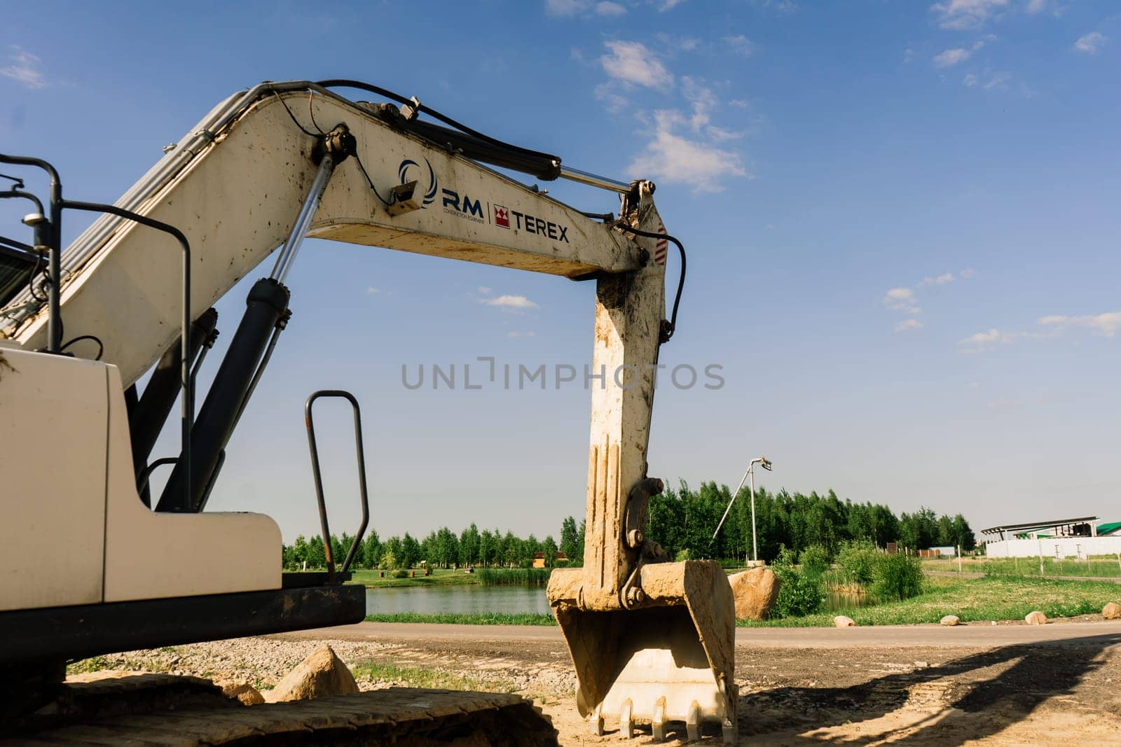 Excavator in quarry extracting stone, soil ground