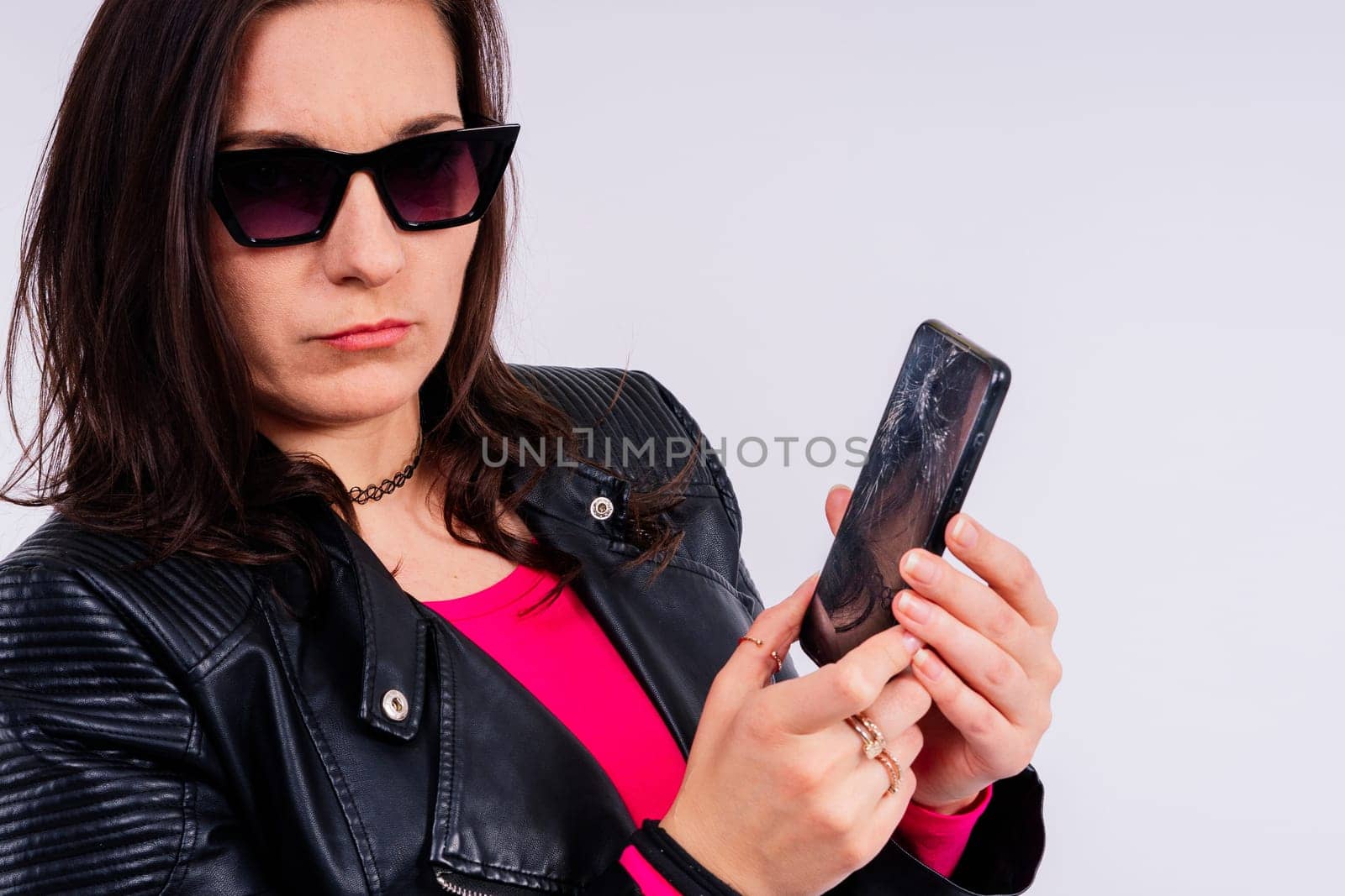 Portrait of a pretty sad woman holding smartphone with broken screen by Zelenin