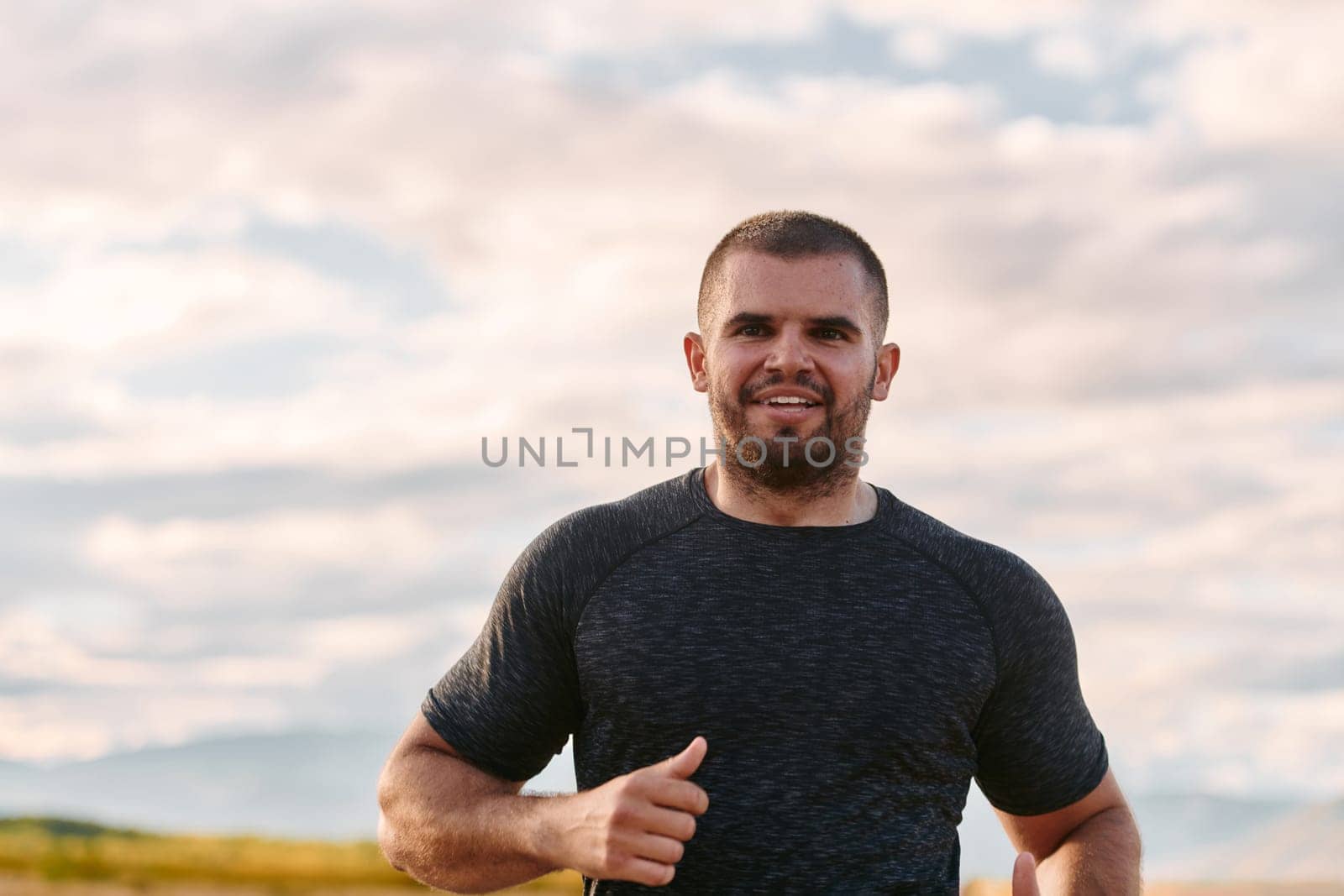 Athletic Man Jogging in the Sun, Preparing His Body for Life's Extreme Challenges by dotshock