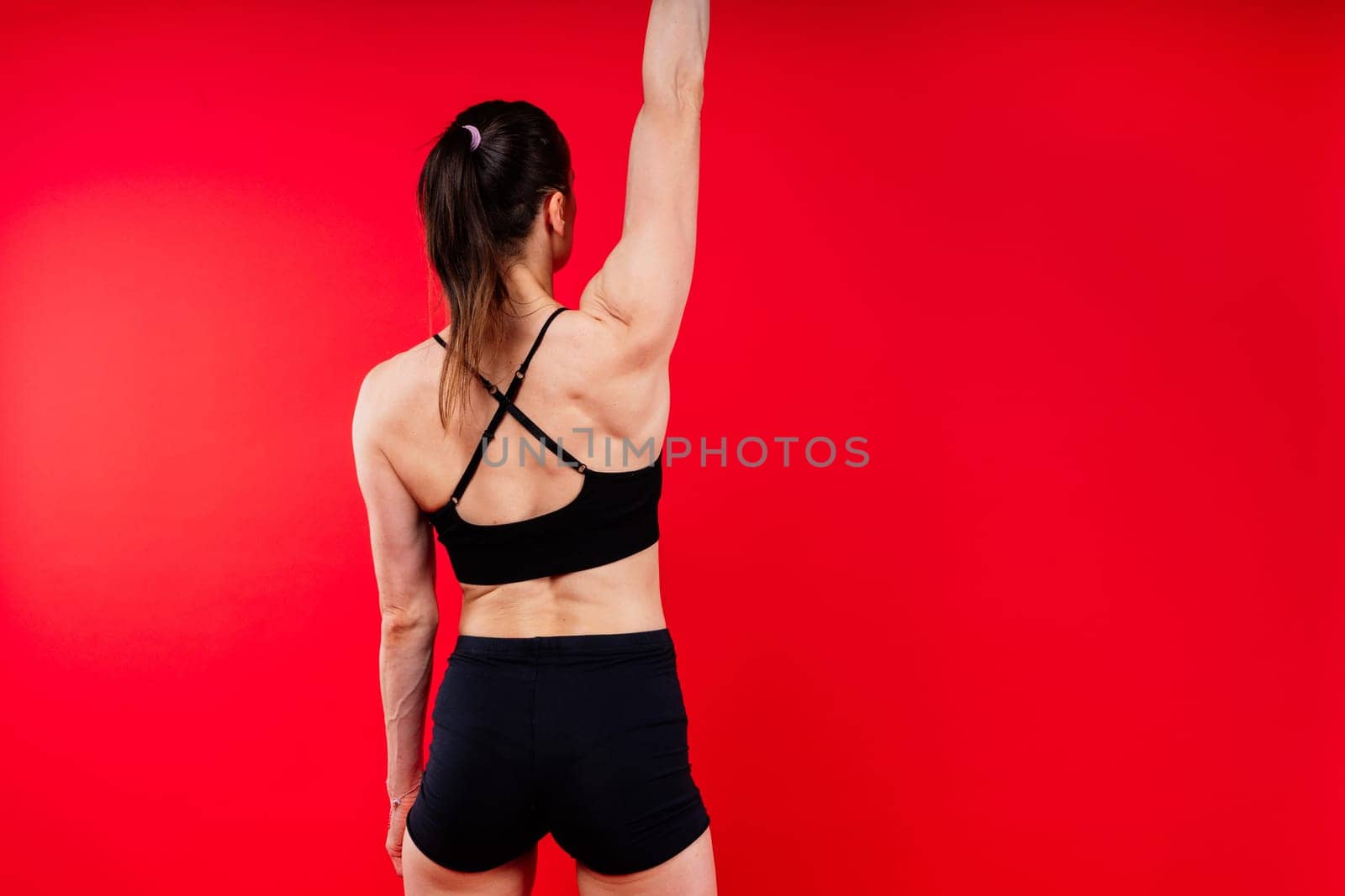 Attractive young athlete with a muscular body exercising crossfit workout with kettlebell.