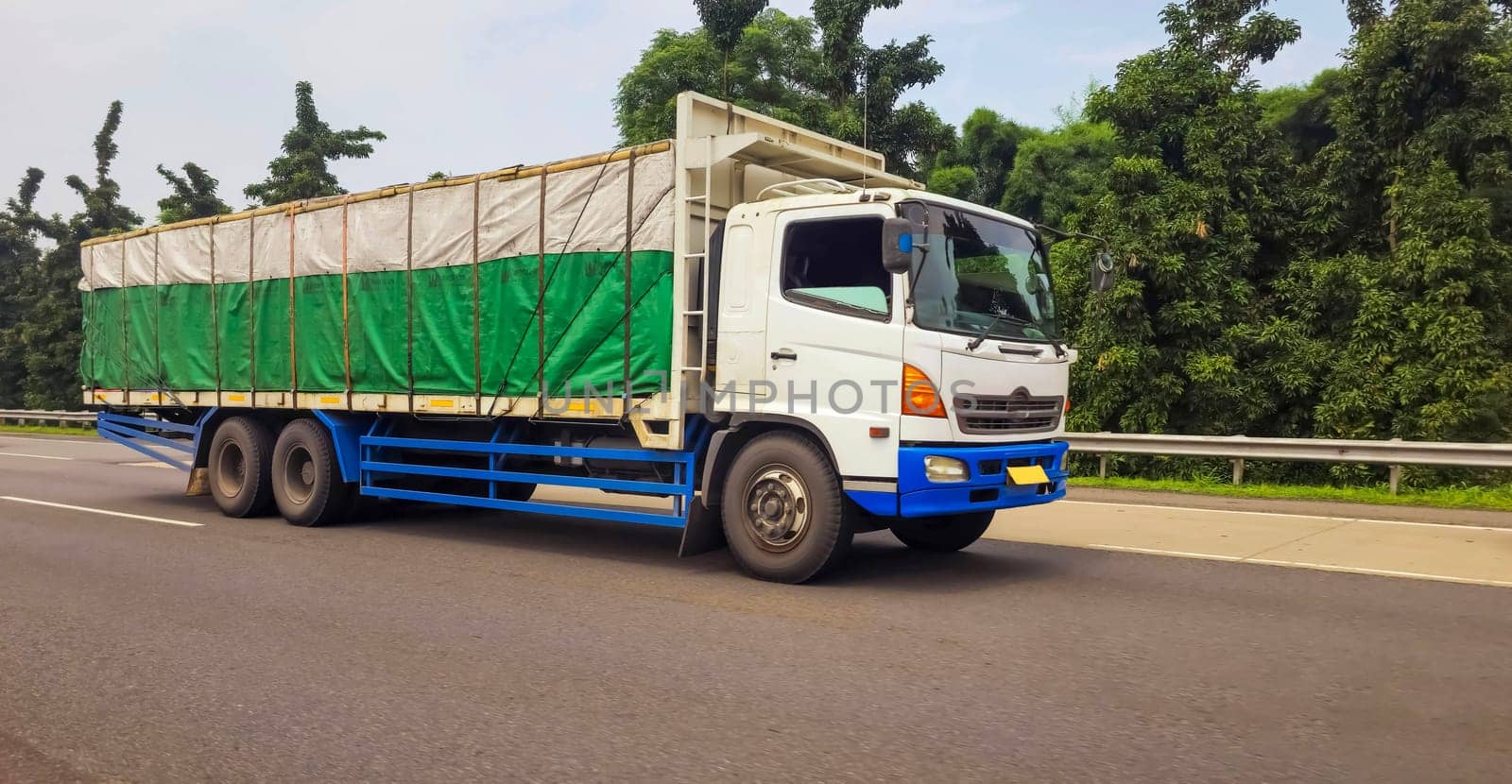 truck one of transportation mode making local commercial delivery at urban city and on the city streets in asia logistical transport system in Asian country Indonesia