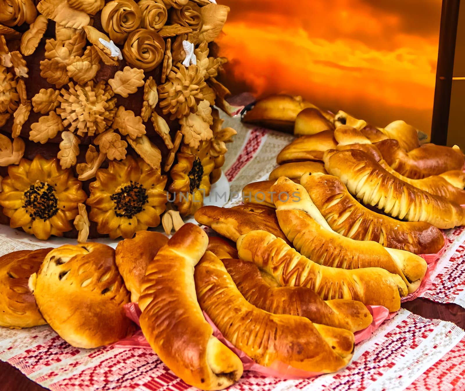 A close-up of freshly baked homemade puff pastry horns filled with rich chocolate cream on a red checkered tablecloth. Golden brown and flaky pastry, perfect for a sweet breakfast or snack.