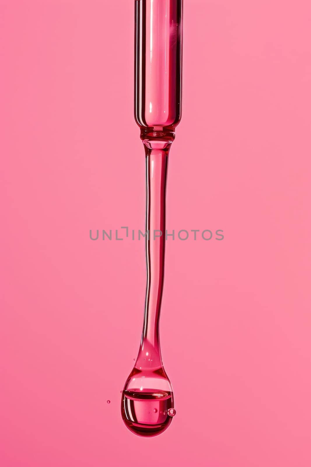 Pink liquid dripping from test tube on pink background for medical experiment and research concept