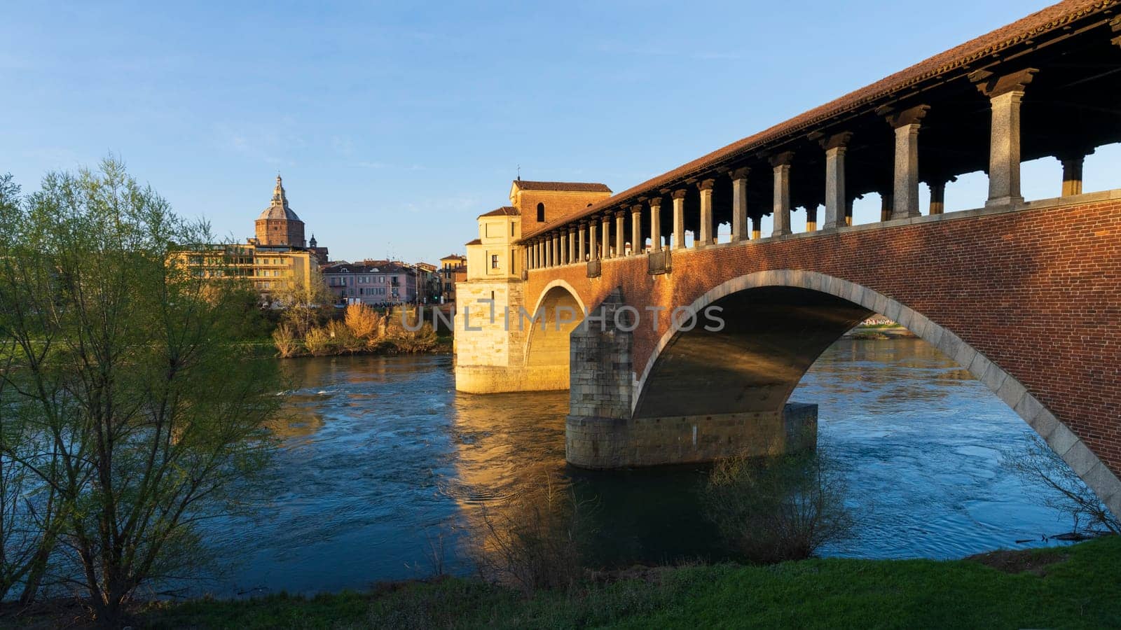 Landscape of Ponte Coperto (covered bridge) and Duomo di Pavia (Pavia Cathedral) in Pavia at sunny day, Lombardy, italy.