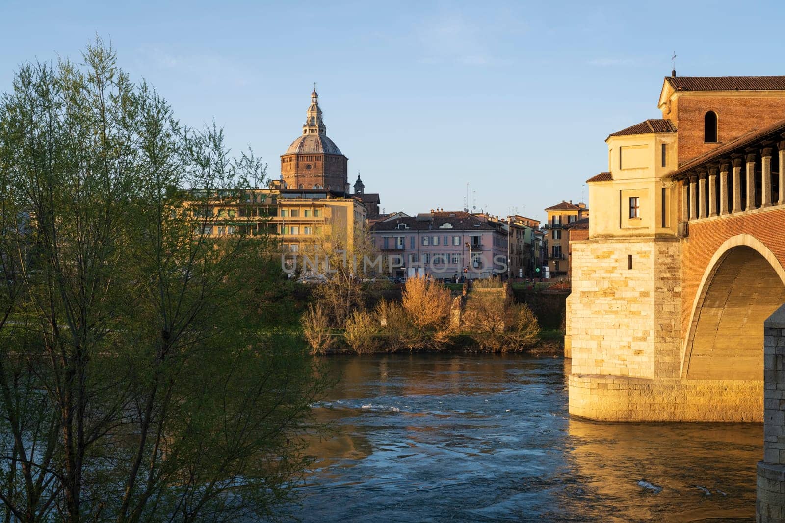 Nice view of Ponte Coperto (covered bridge) and Duomo di Pavia (Pavia Cathedral) in Pavia at sunny day, Lombardy, italy.