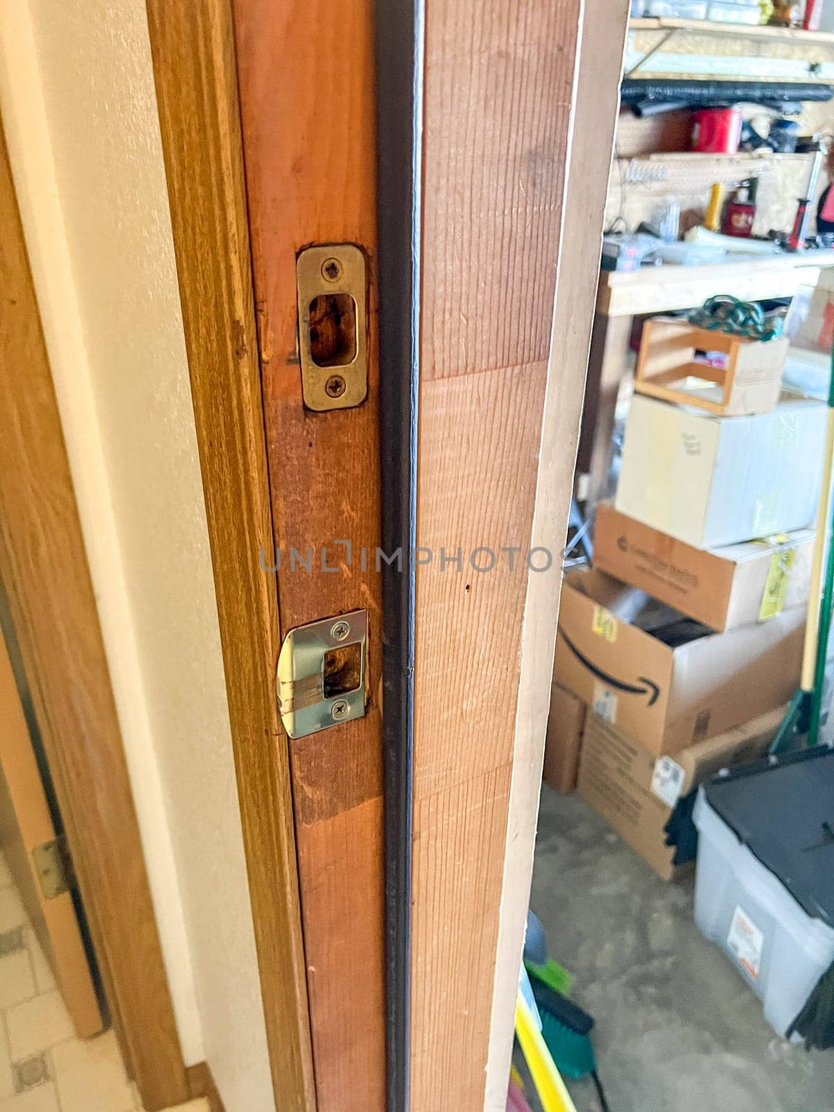 Close-Up of Door Frame with Removed Lock Hardware by arinahabich