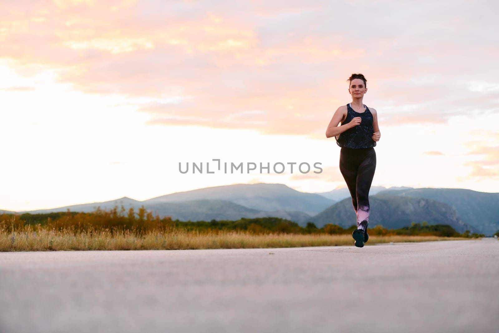 Determined Athlete Running in the Sun amidst Beautiful Nature by dotshock