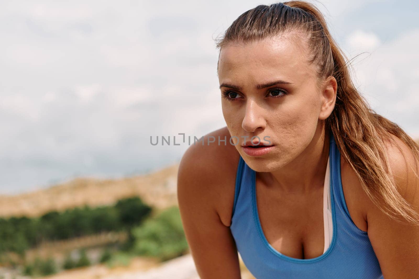 Determined Woman Athlete Preparing for Morning Run by dotshock
