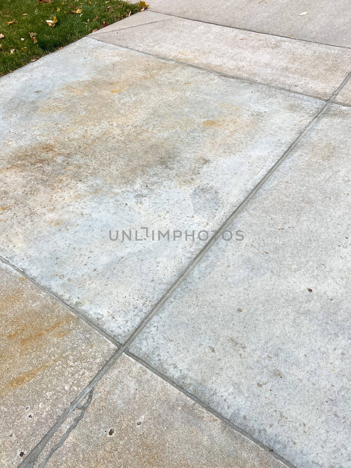 Repaired Concrete Driveway Joints and Cracks Close-Up by arinahabich