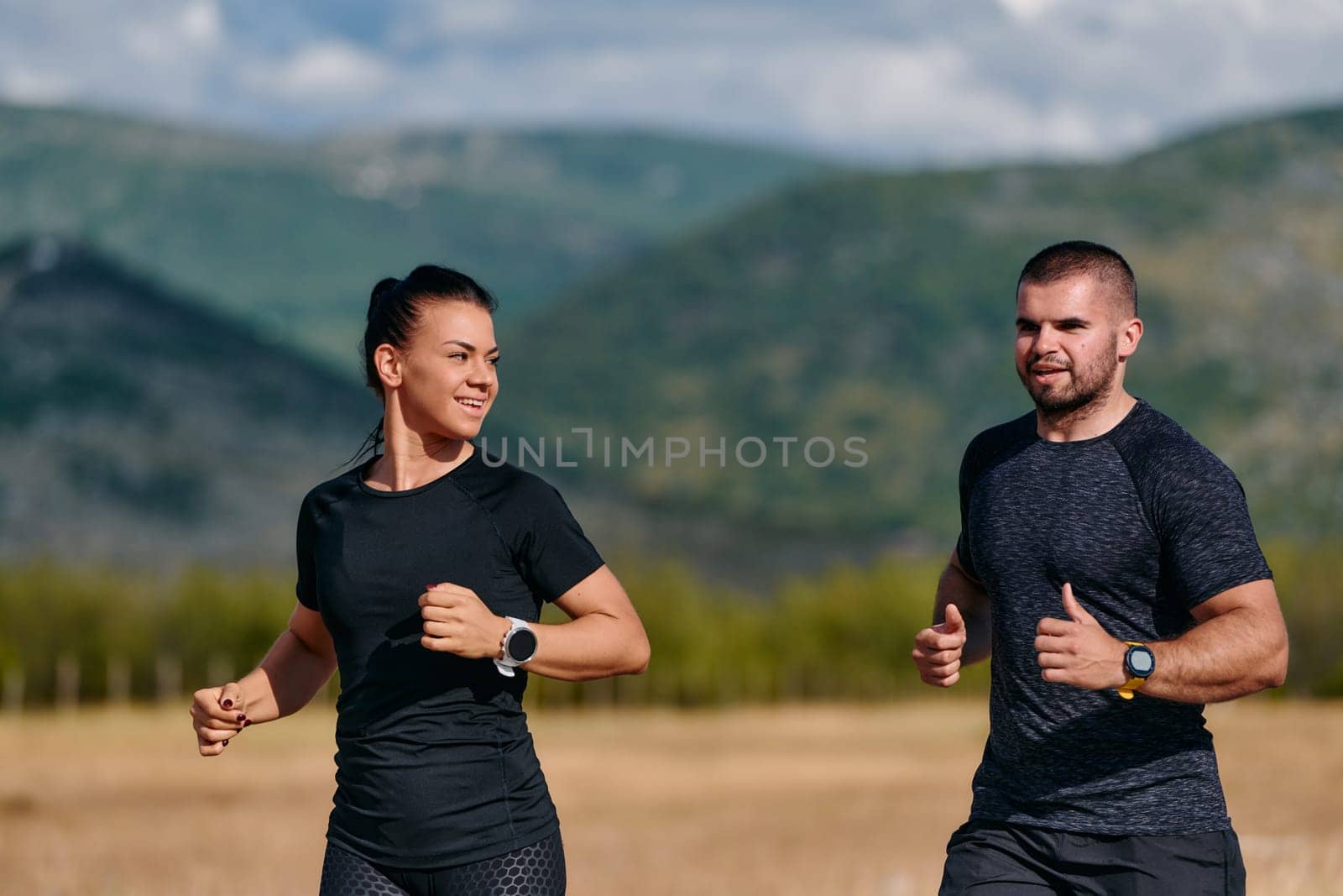 A couple embraces a healthy lifestyle by running together on a sunny day, exemplifying dedication to fitness and wellness in their partnership