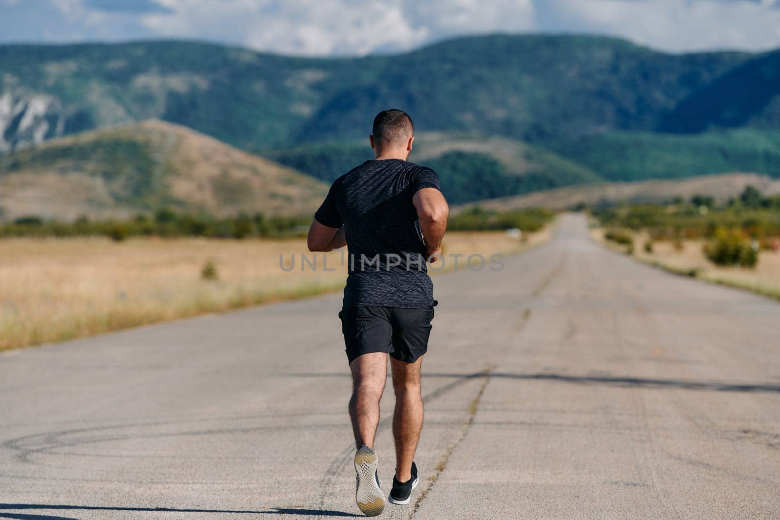 Athletic Man Jogging in the Sun, Preparing His Body for Life's Extreme Challenges by dotshock