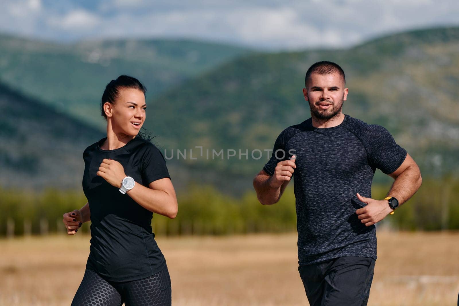 A couple embraces a healthy lifestyle by running together on a sunny day, exemplifying dedication to fitness and wellness in their partnership