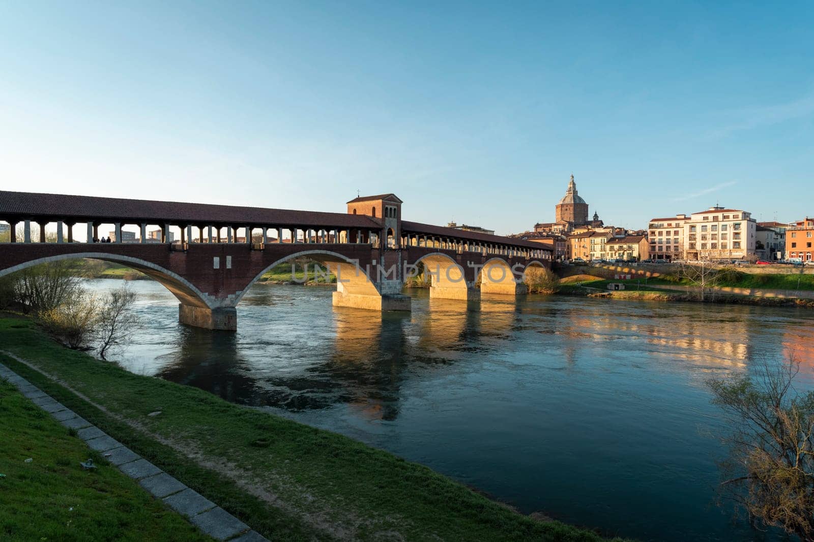 Landscape of Ponte Coperto (covered bridge) and Duomo di Pavia (Pavia Cathedral) in Pavia at sunny day, Lombardy, italy.