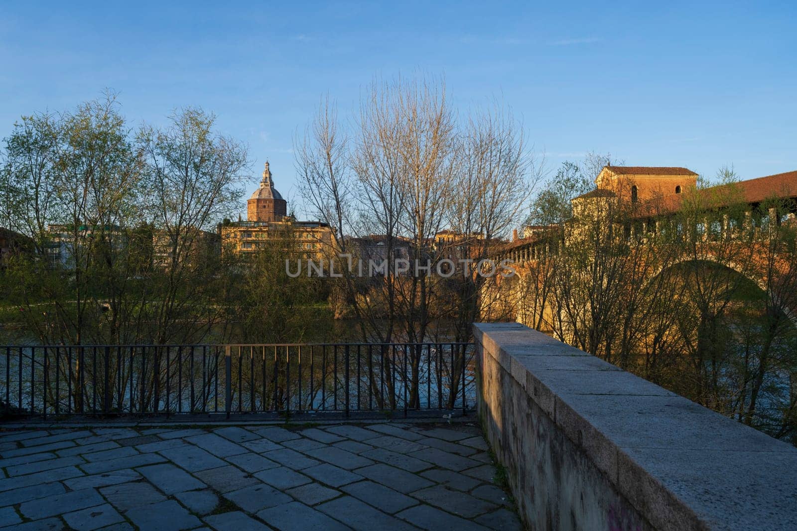 Nice view of Ponte Coperto (covered bridge) and Duomo di Pavia (Pavia Cathedral) in Pavia at sunny day, Lombardy, italy.