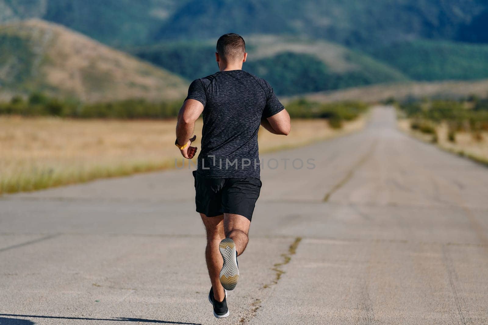 Athletic Man Jogging in the Sun, Preparing His Body for Life's Extreme Challenges by dotshock