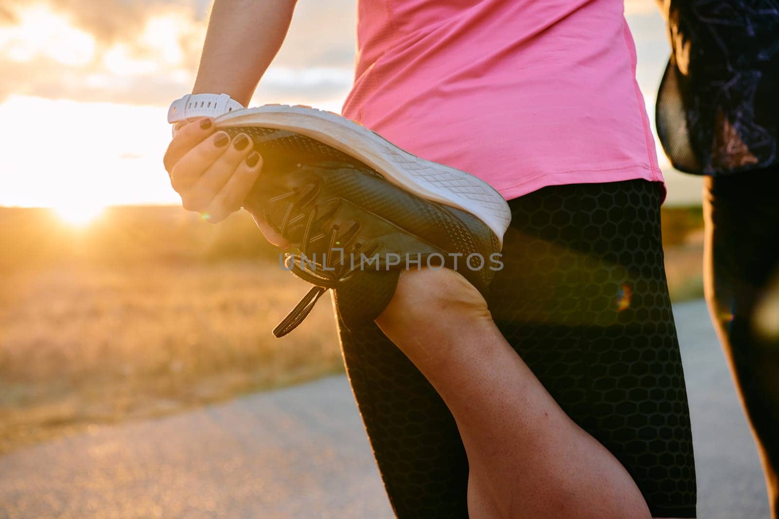 Womens athletes are seen stretching after an intense run, epitomizing dedication to fitness and appreciation for nature's beauty.