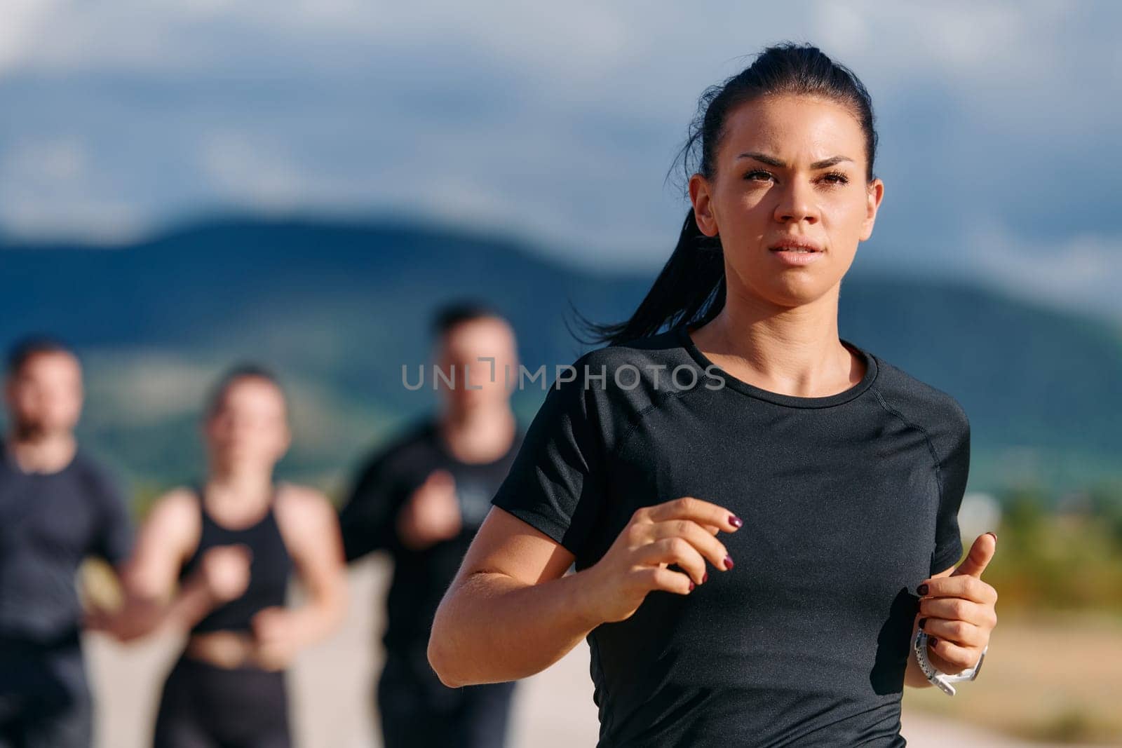 A professional athletic team as they train rigorously, running towards peak performance in preparation for an upcoming marathon.