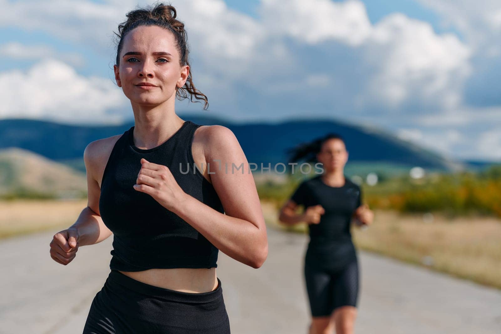 Two friends jog side by side on a sunny day, strengthening their bodies for life's extreme challenges, embodying the power of friendship and determination