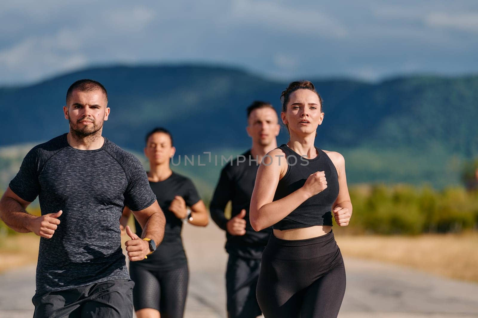 A professional athletic team as they train rigorously, running towards peak performance in preparation for an upcoming marathon.