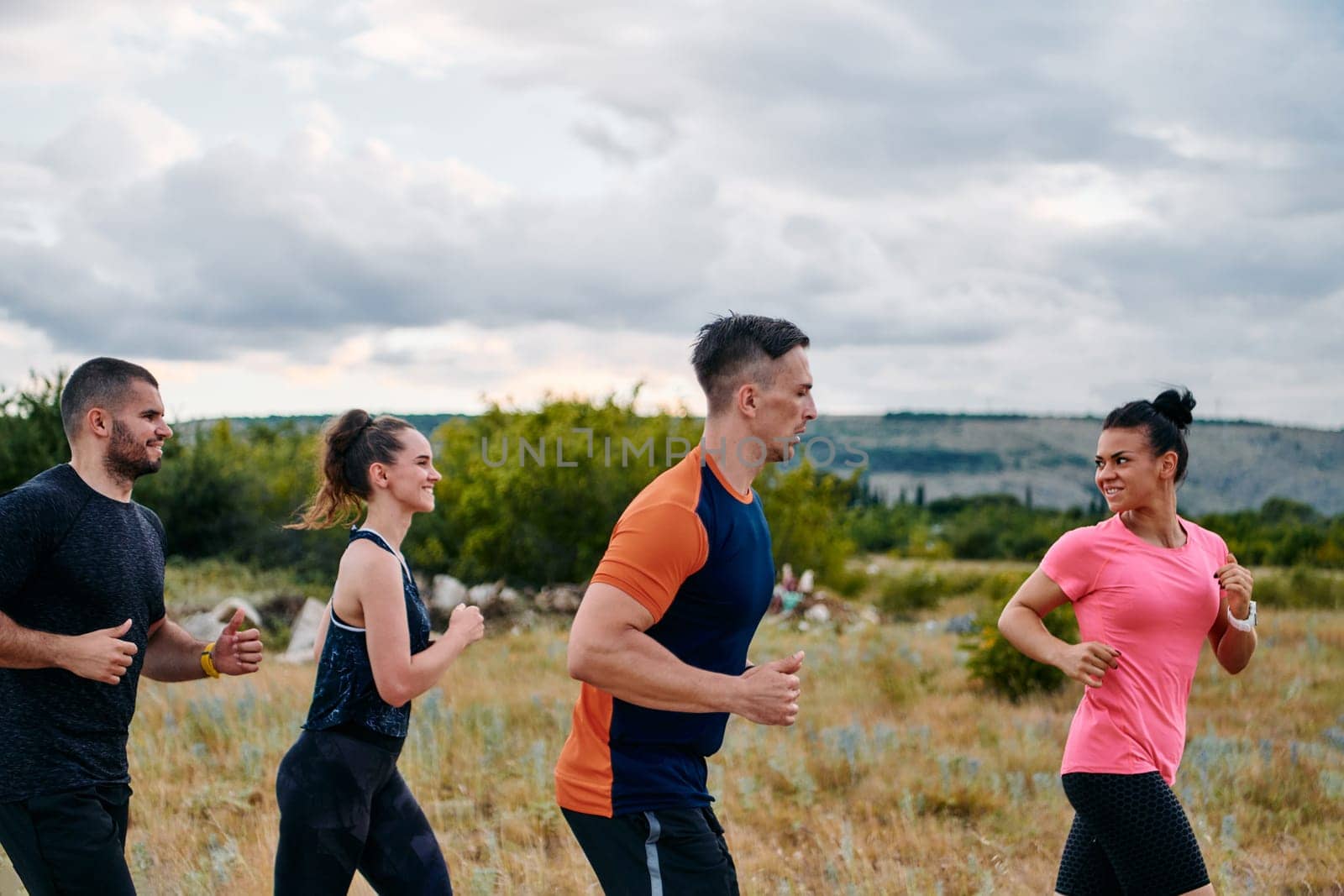 A professional athletic team as they train rigorously, running towards peak performance in preparation for an upcoming marathon.