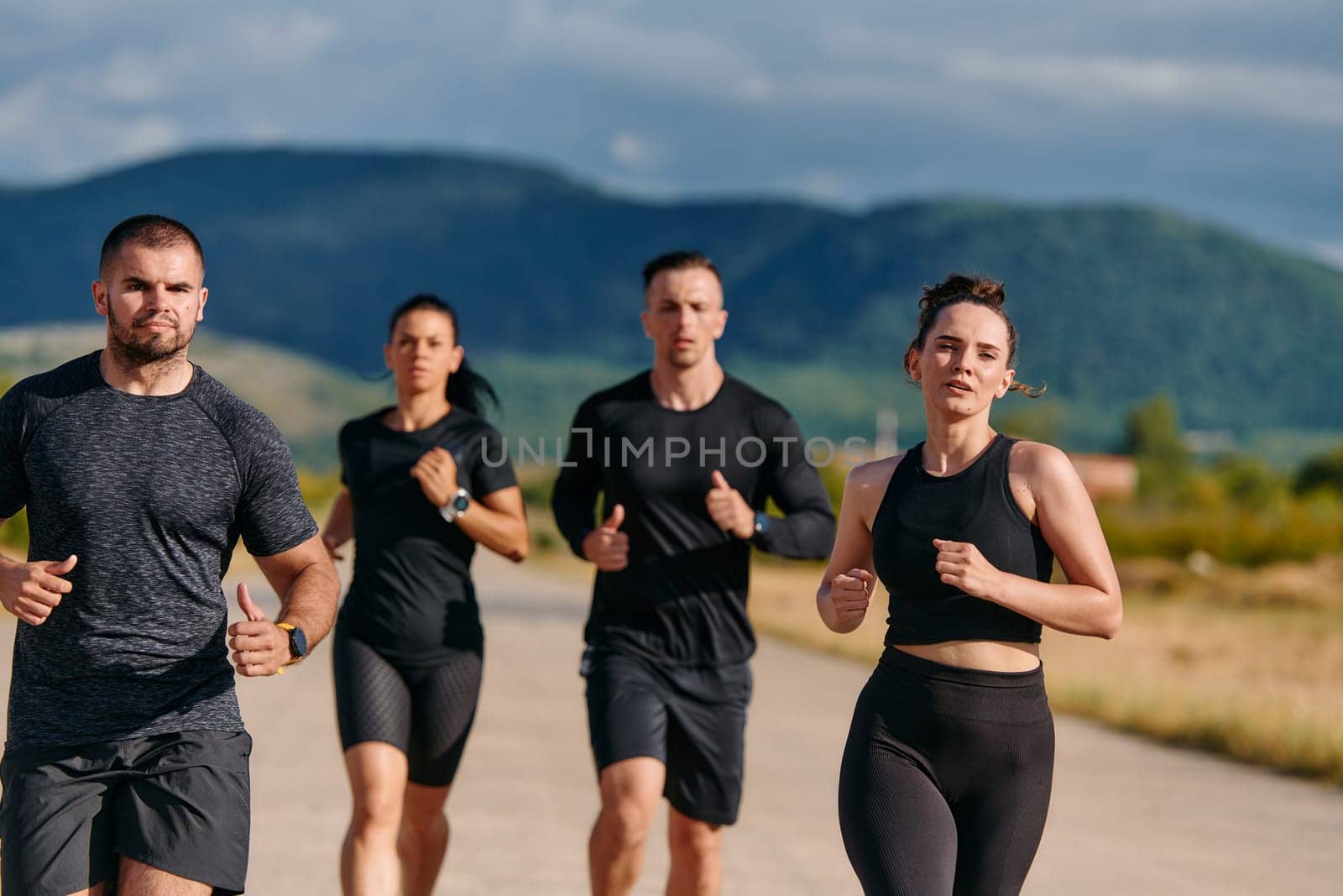 A professional athletic team as they train rigorously, running towards peak performance in preparation for an upcoming marathon.