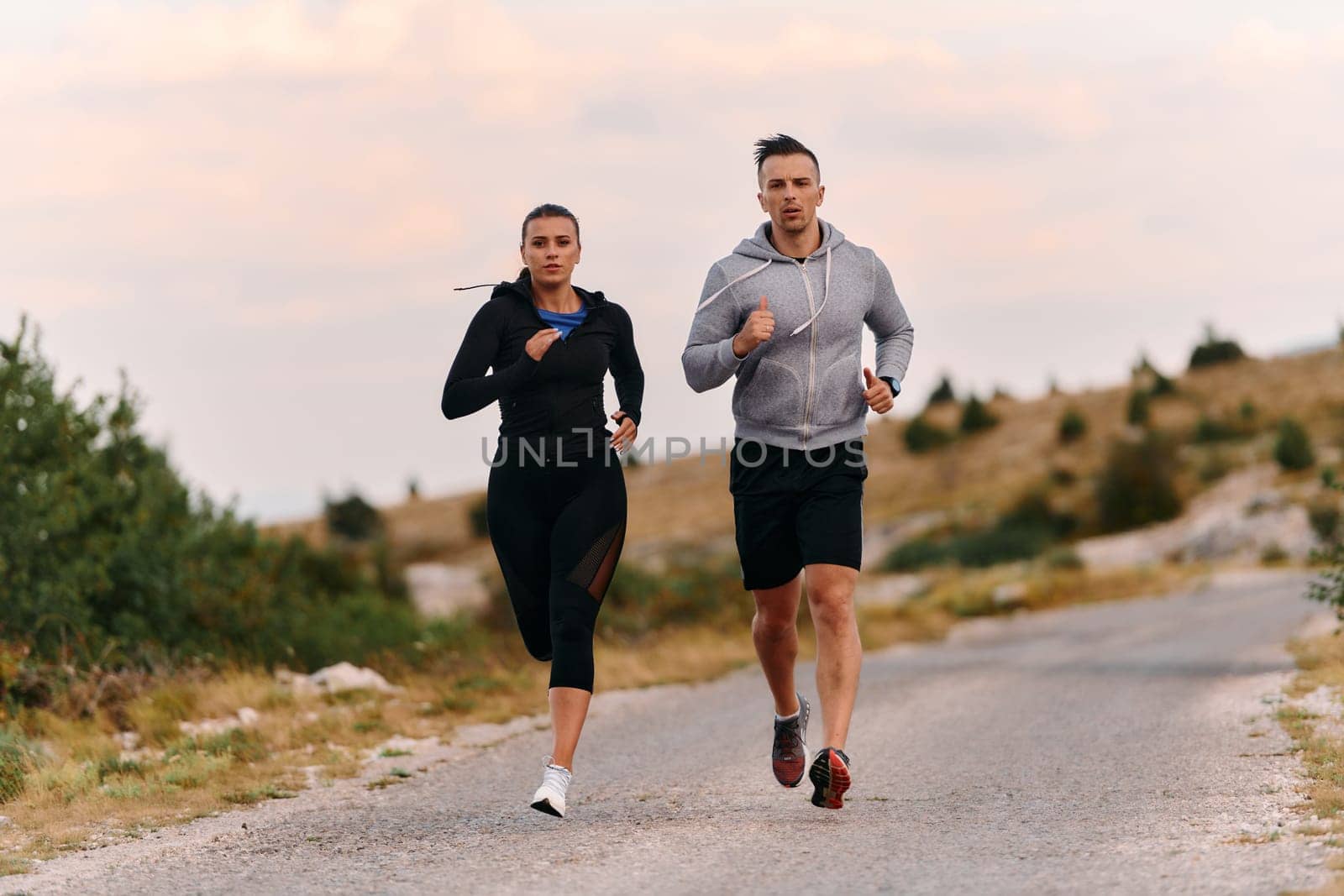 Couple conquer challenging mountain trails during an invigorating morning run.