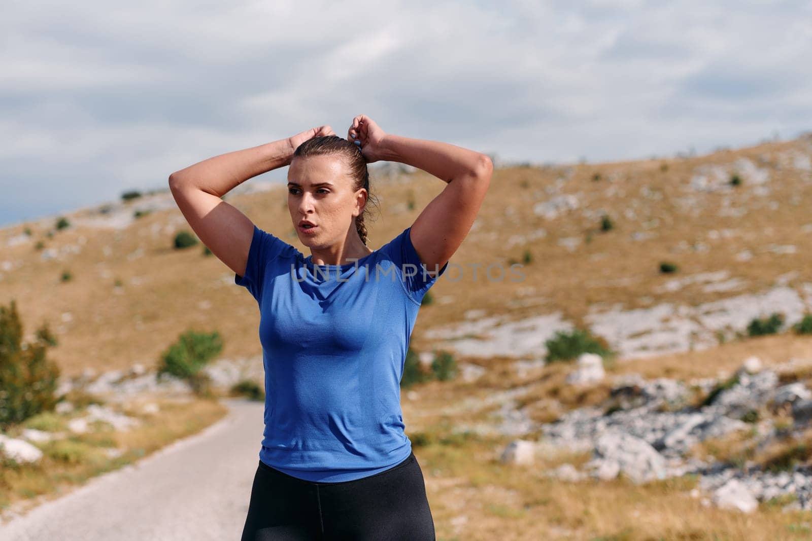 Determined Woman Athlete Preparing for Morning Run by dotshock