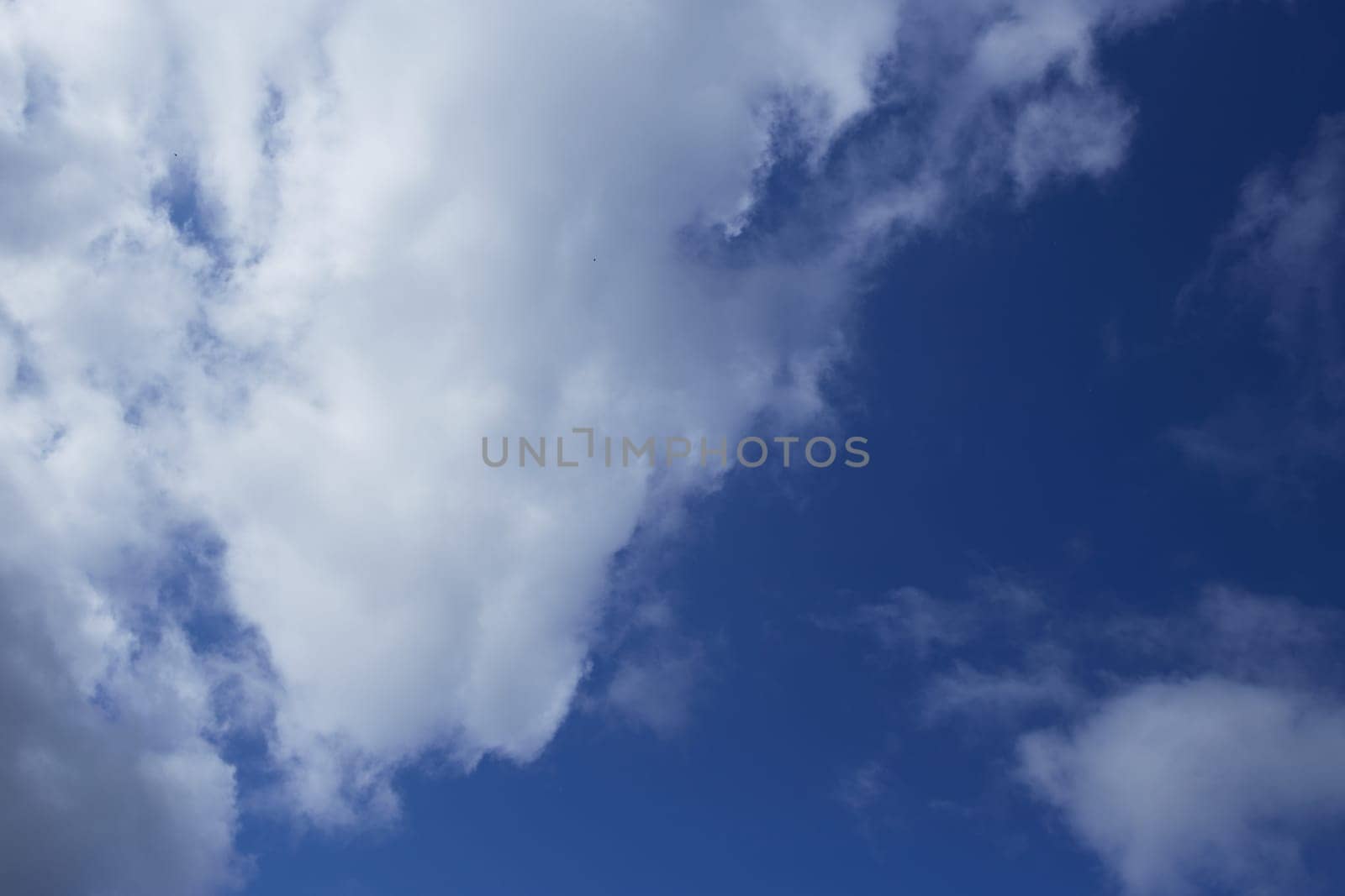 a photo of a calm blue sky with white clouds. Screen saver, wallpaper, pattern.