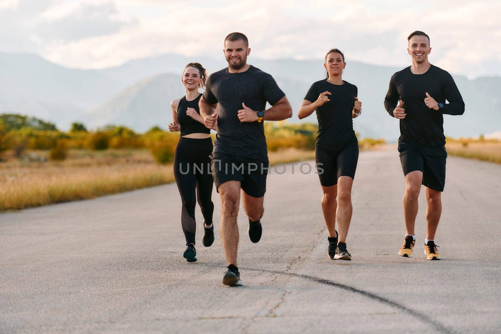 A professional athletic team as they train rigorously, running towards peak performance in preparation for an upcoming marathon.