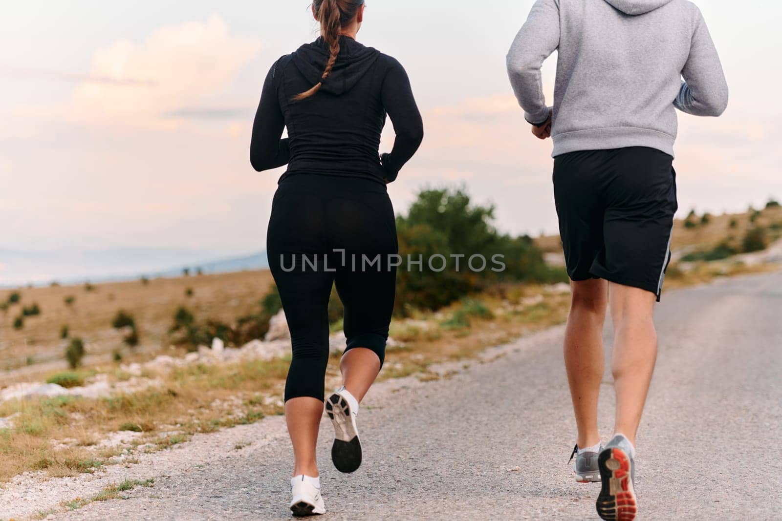 Couple conquer challenging mountain trails during an invigorating morning run.