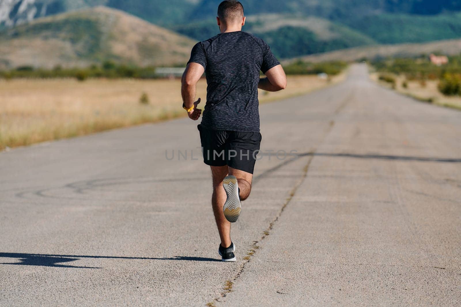 An athletic man jogs under the sun, conditioning his body for life's extreme challenges, exuding determination and strength in his preparation for the journey ahead