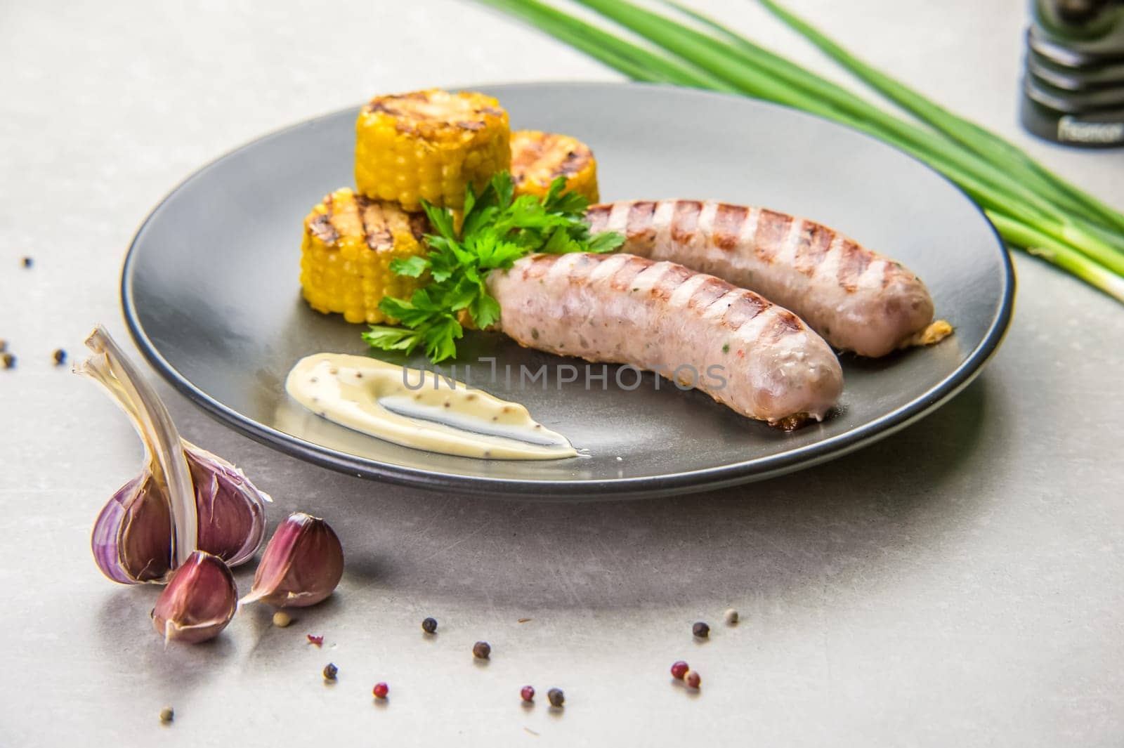 homemade sausages on a platter with roasted corn by Mixa74