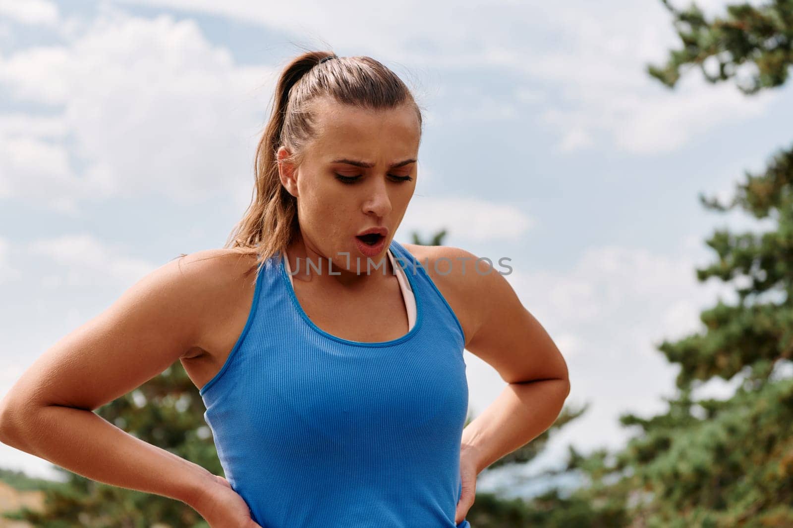 A woman takes a moment to rest and recuperate after an intense run, finding solace and rejuvenation in the tranquility of her surroundings.