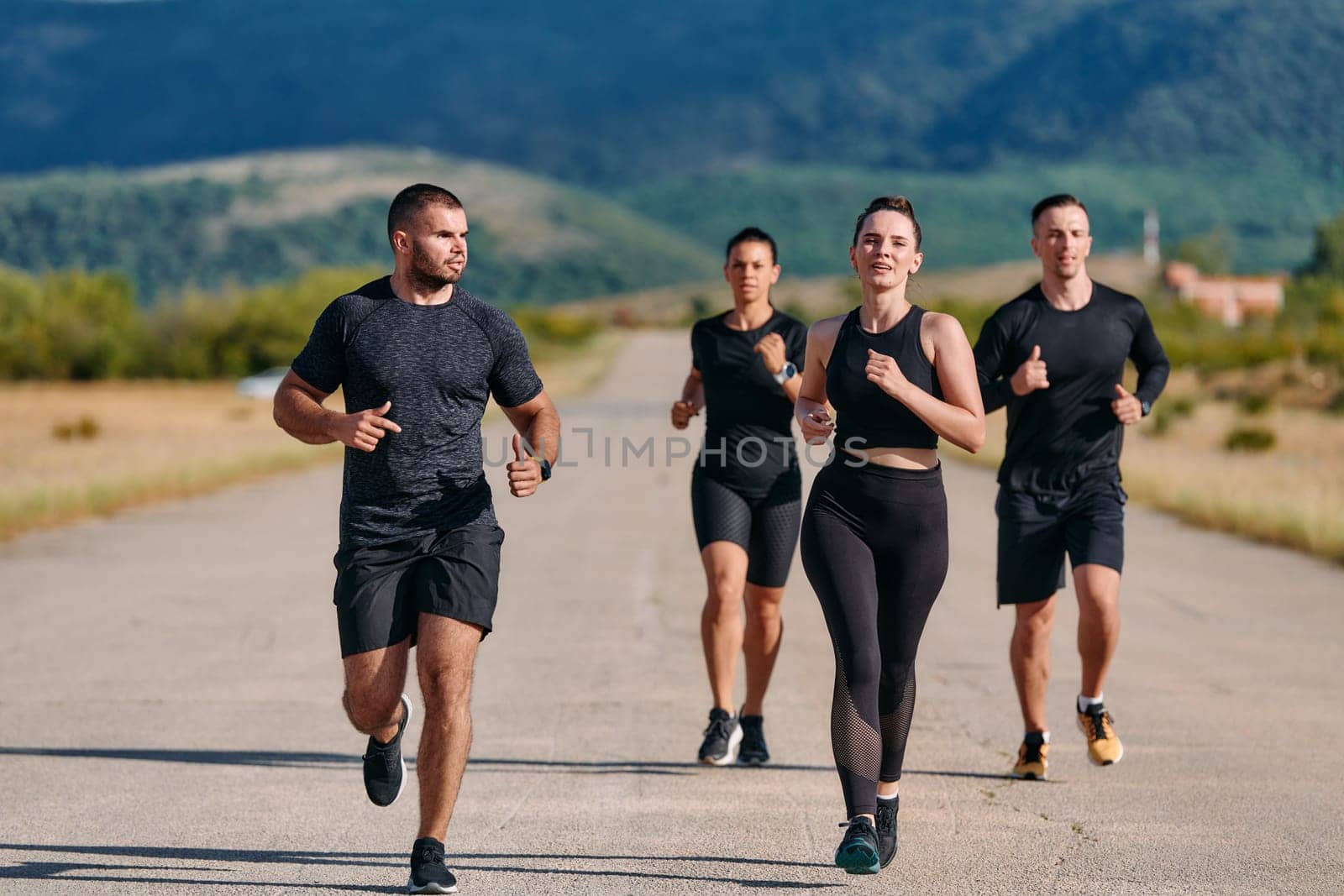 A professional athletic team as they train rigorously, running towards peak performance in preparation for an upcoming marathon.