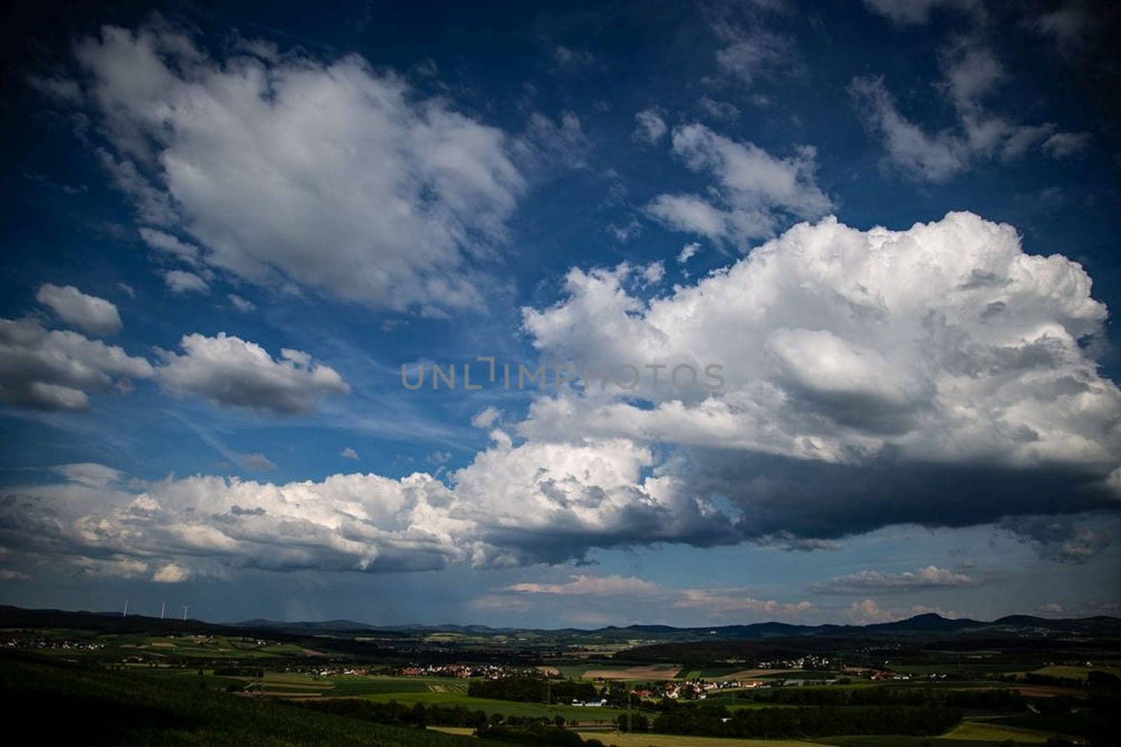 Beauty cloud against a blue sky background. Sky slouds. Blue sky with cloudy weather, nature cloud over the landskape. Over the land white clouds, blue sky and sun. High quality photo