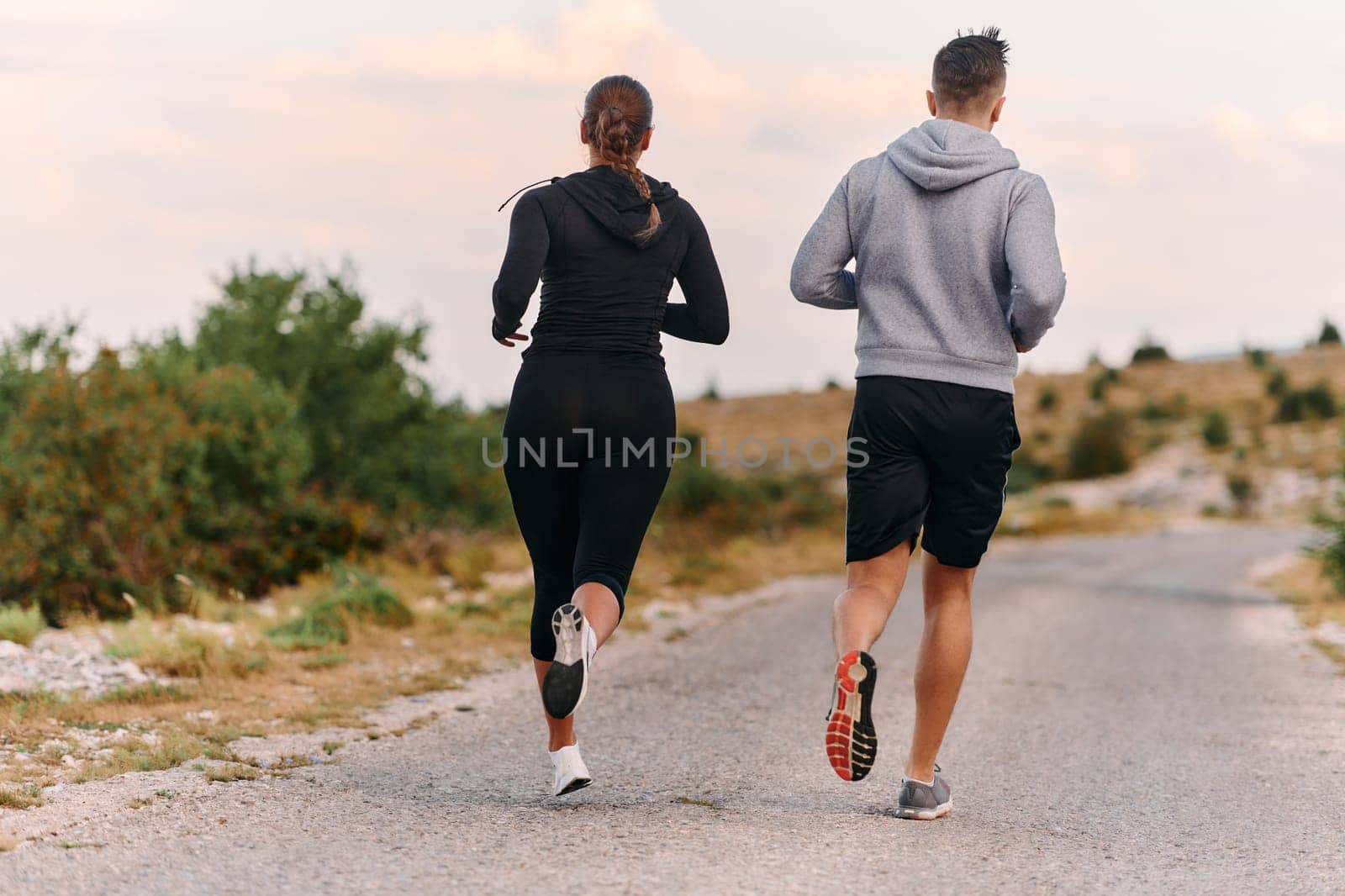 Couple conquer challenging mountain trails during an invigorating morning run.