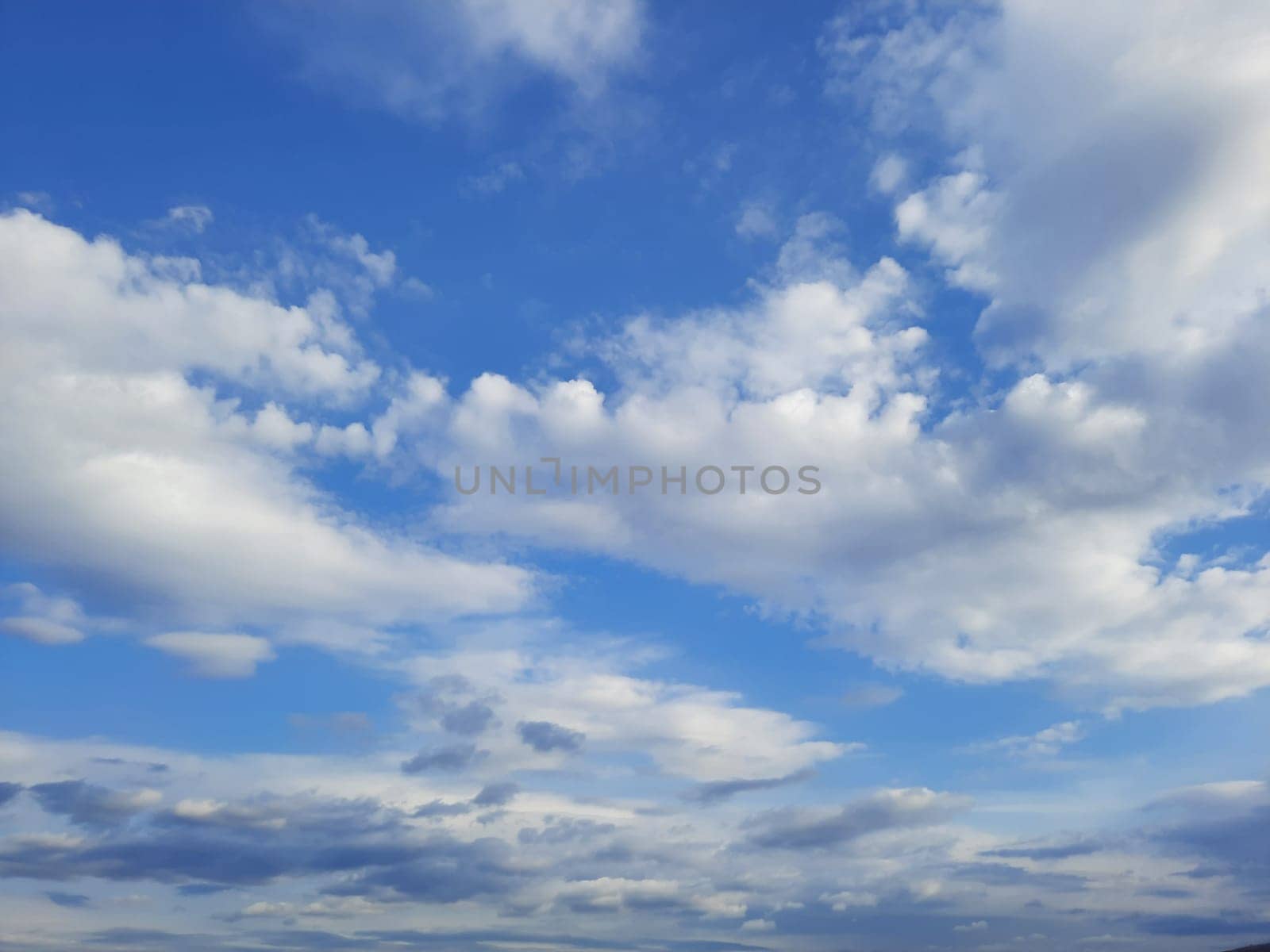 Beauty cloud against a blue sky background. Sky slouds. Blue sky with cloudy weather, nature cloud. White clouds, blue sky and sun. High quality photo