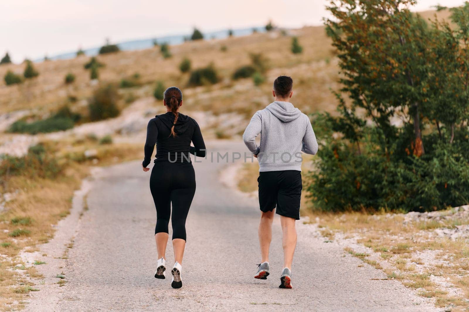 Couple conquer challenging mountain trails during an invigorating morning run.