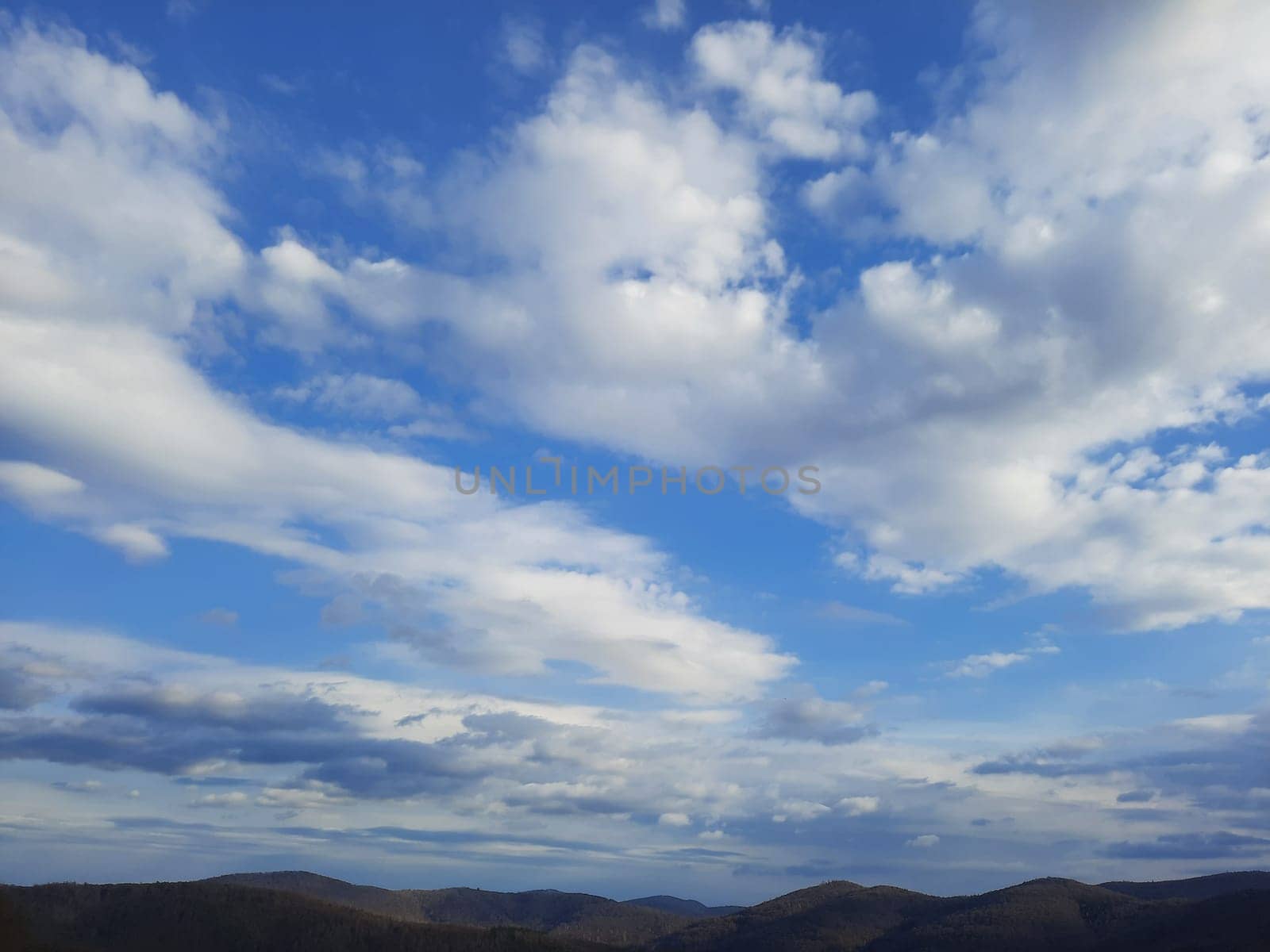 Beauty cloud against a blue sky background. Sky slouds. Blue sky with cloudy weather, nature cloud. White clouds, blue sky and sun. by Costin