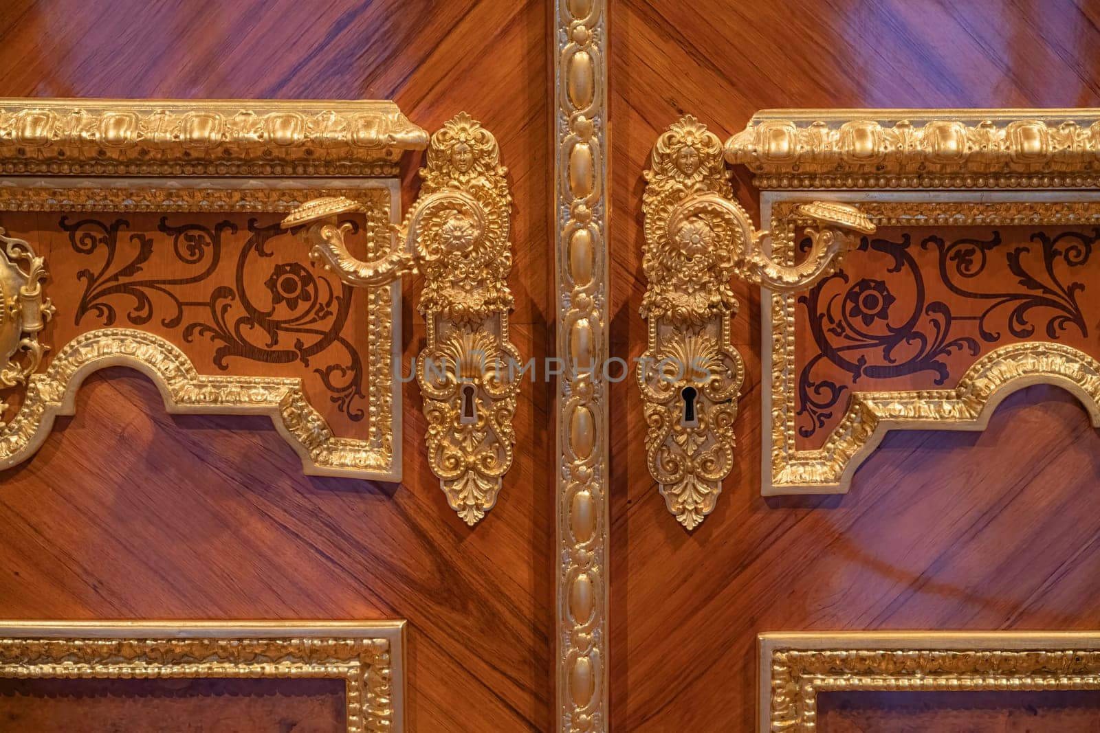 handles with a lock on an old wooden door. photo