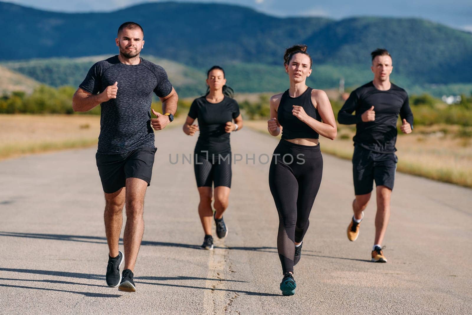 A professional athletic team as they train rigorously, running towards peak performance in preparation for an upcoming marathon.